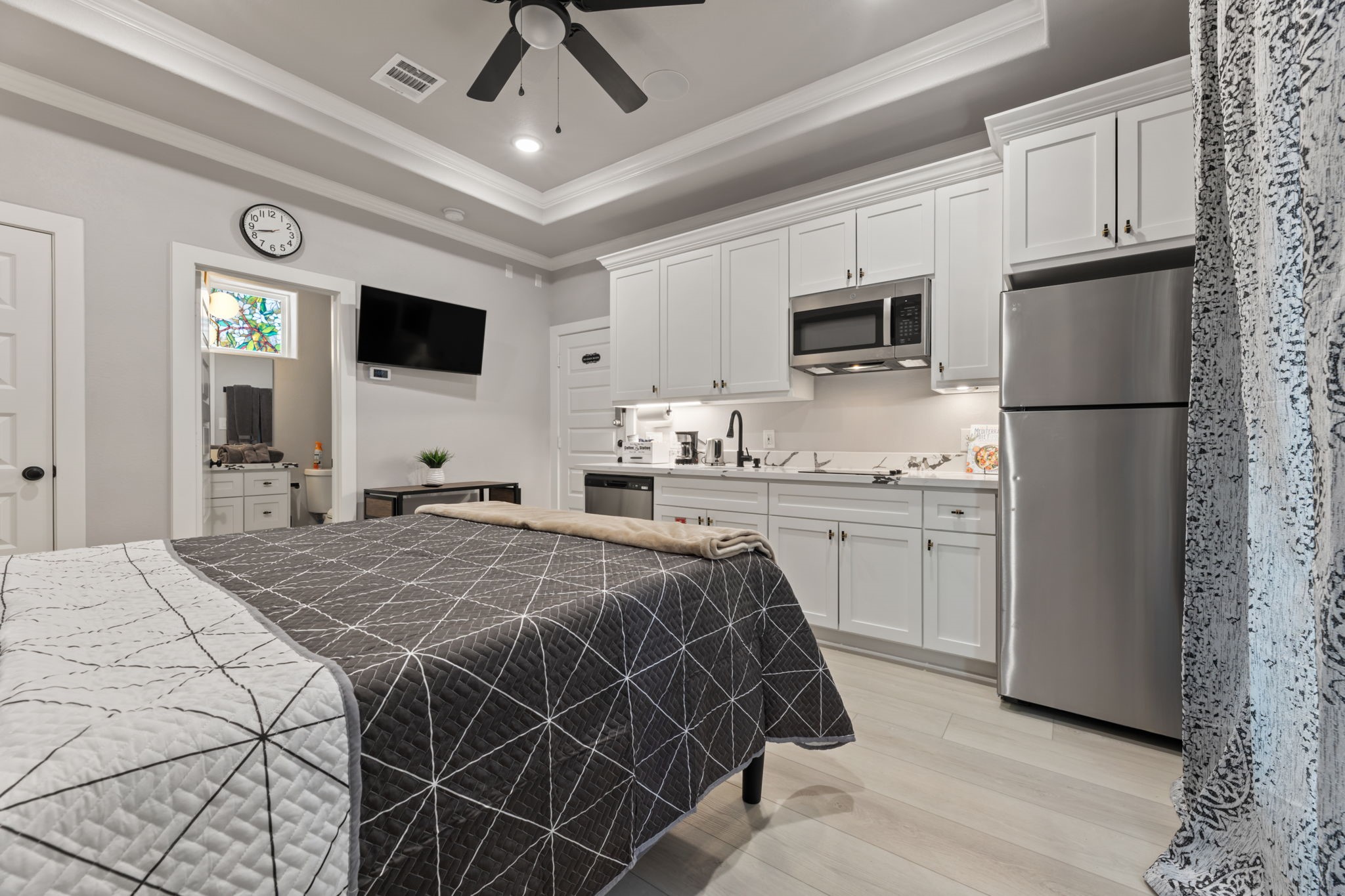 8521 Brandon Street, Unit STUDIO Houston, TX 77051 - Photo 2 of 14 a bedroom with a bed and a television