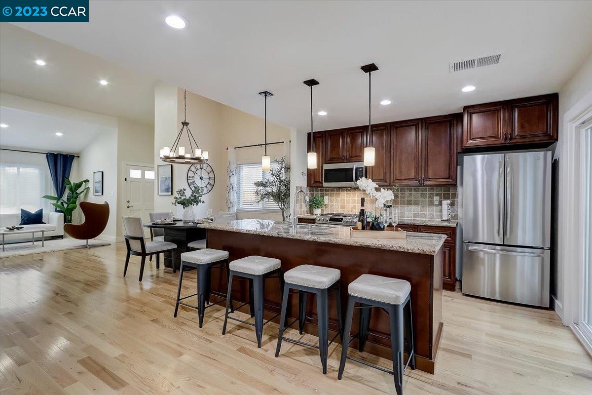 4453 Birch Bark Road Concord, CA 94521 - Photo 1 of 1 a kitchen with stainless steel appliances granite countertop a table chairs refrigerator and microwave