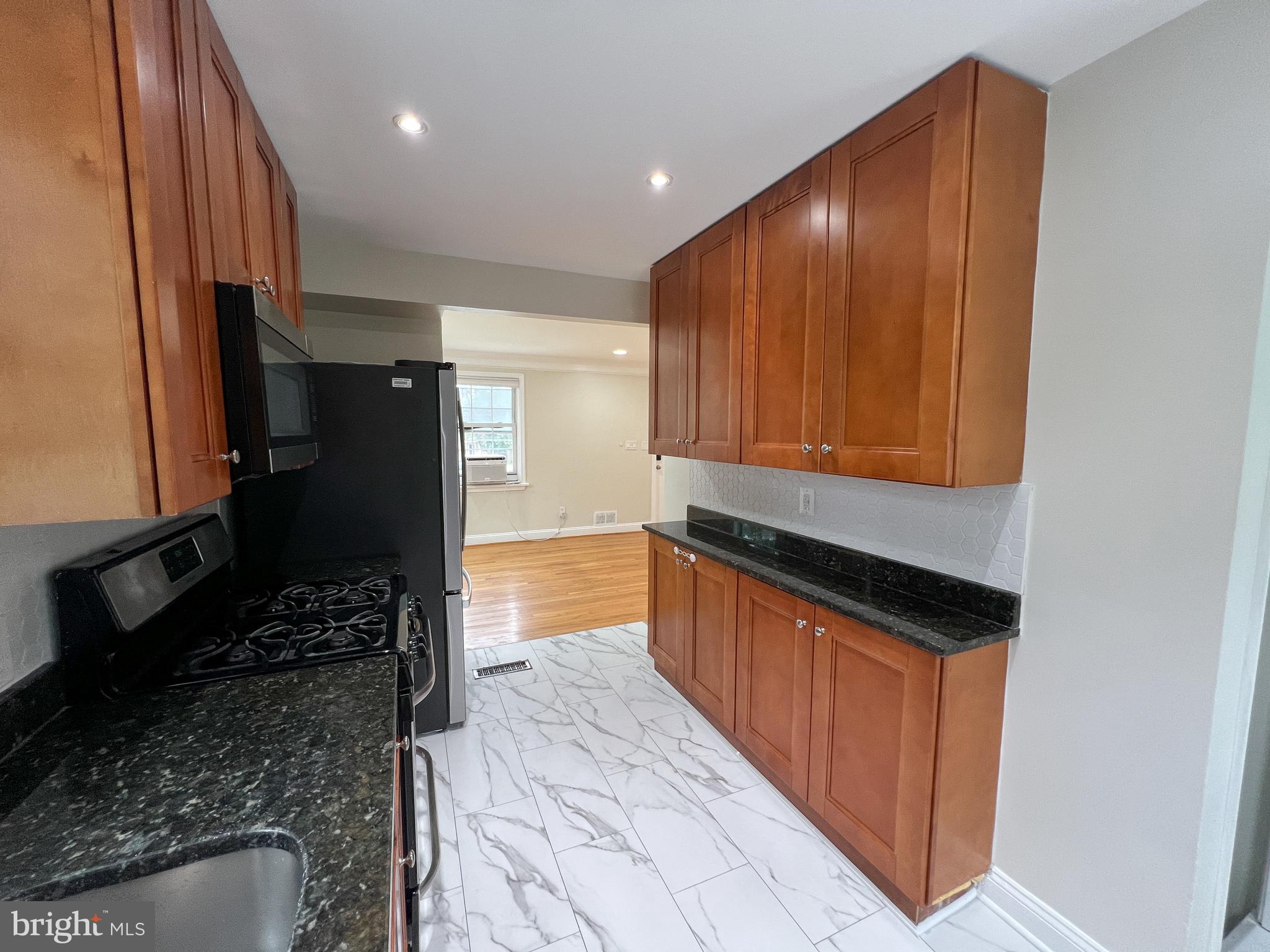 2515 Randolph Road Silver Spring, MD 20902 - Photo 16 of 36 a kitchen with stainless steel appliances granite countertop a refrigerator and a stove