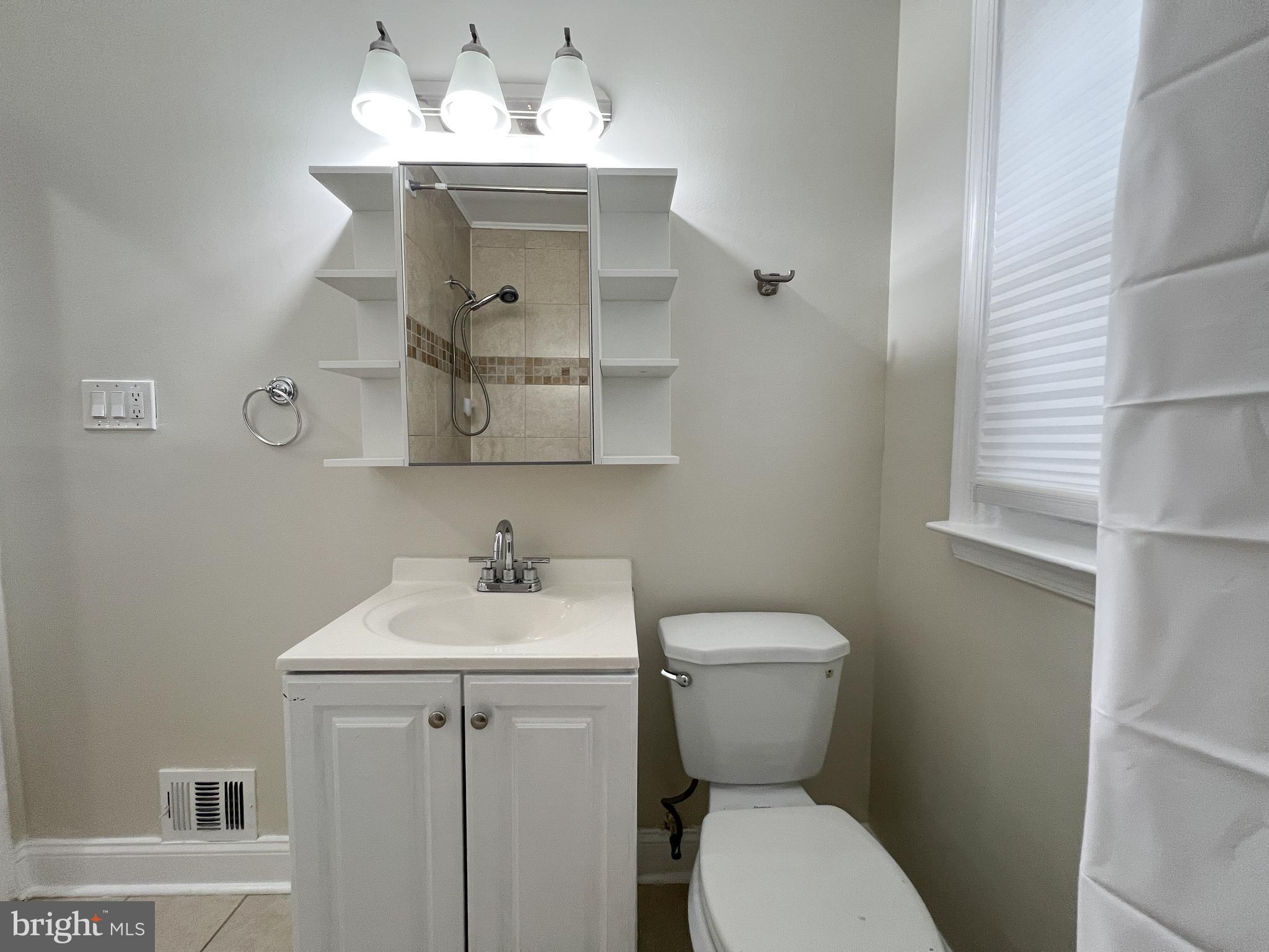 2515 Randolph Road Silver Spring, MD 20902 - Photo 19 of 36 a bathroom with a toilet sink and mirror