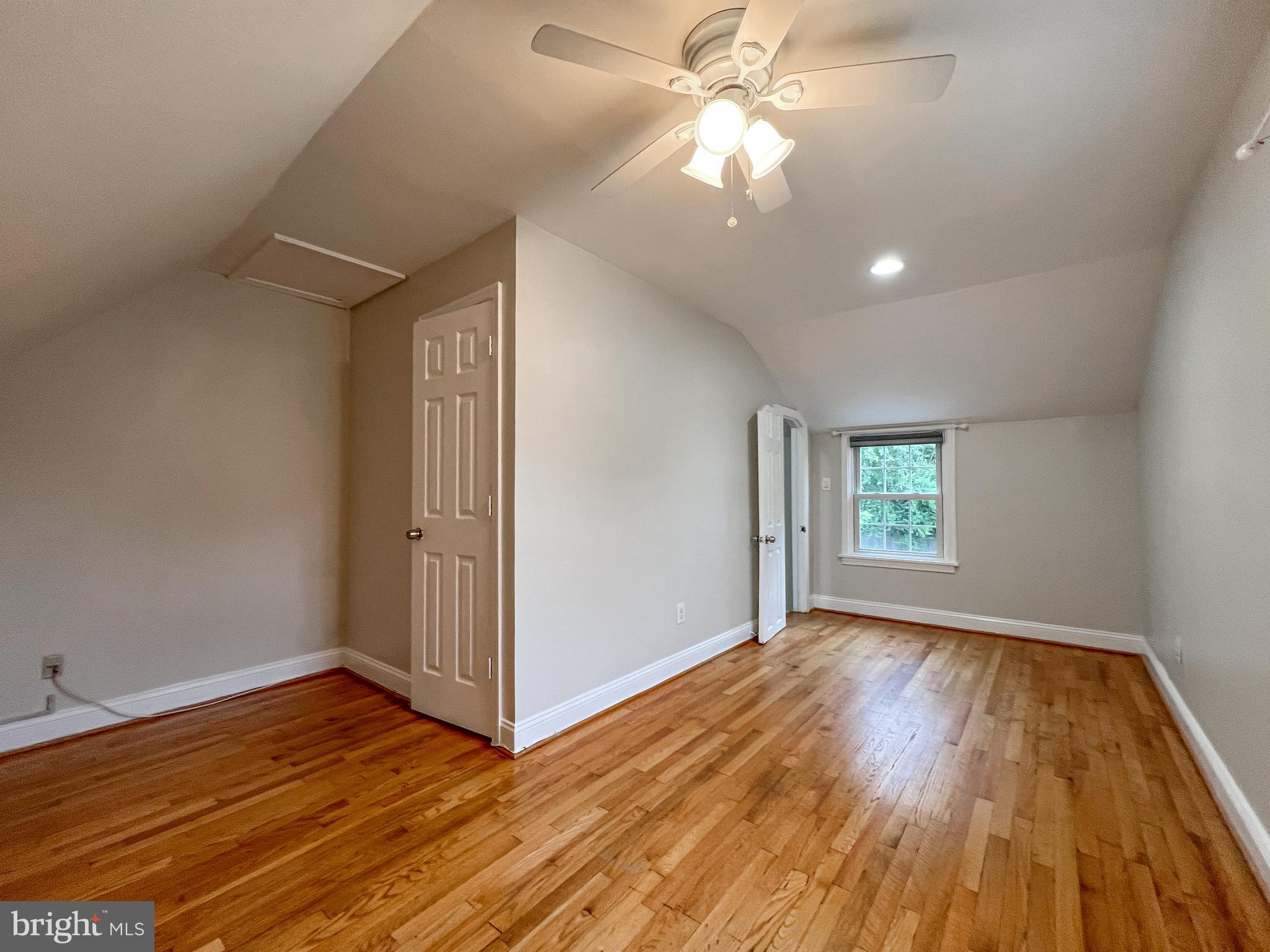 2515 Randolph Road Silver Spring, MD 20902 - Photo 23 of 36 an empty room with wooden floor chandelier fan and windows