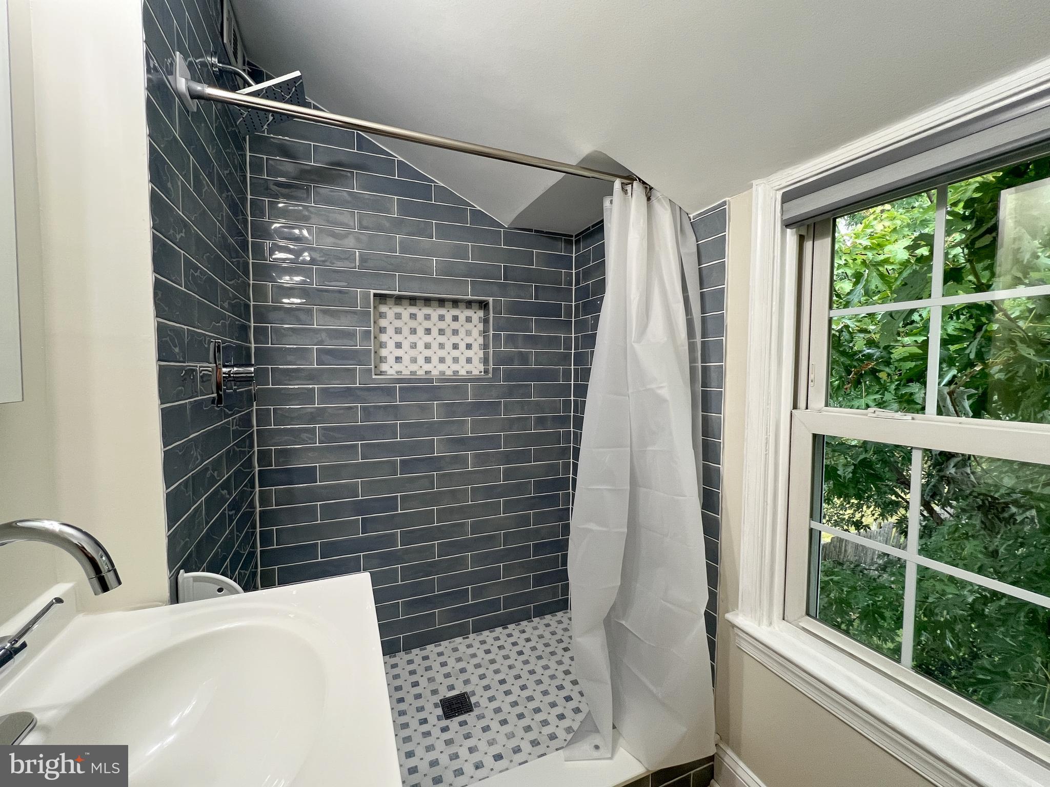 2515 Randolph Road Silver Spring, MD 20902 - Photo 25 of 36 a bathroom with a sink toilet and shower