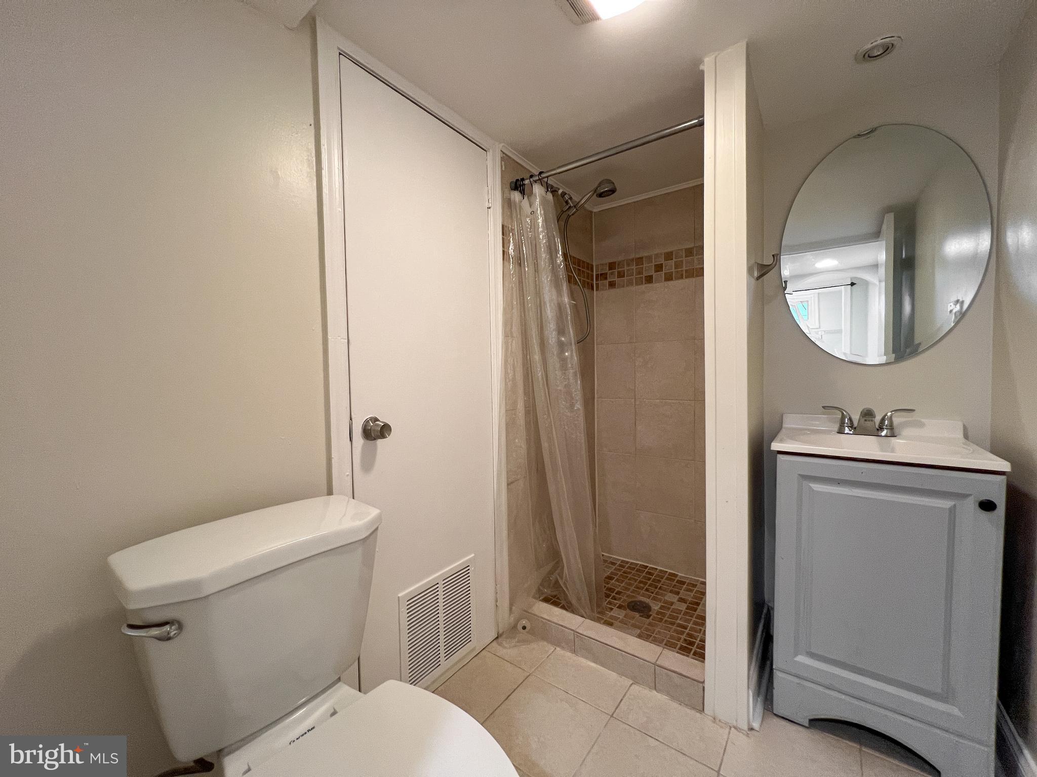 2515 Randolph Road Silver Spring, MD 20902 - Photo 33 of 36 a bathroom with a granite countertop toilet sink and shower