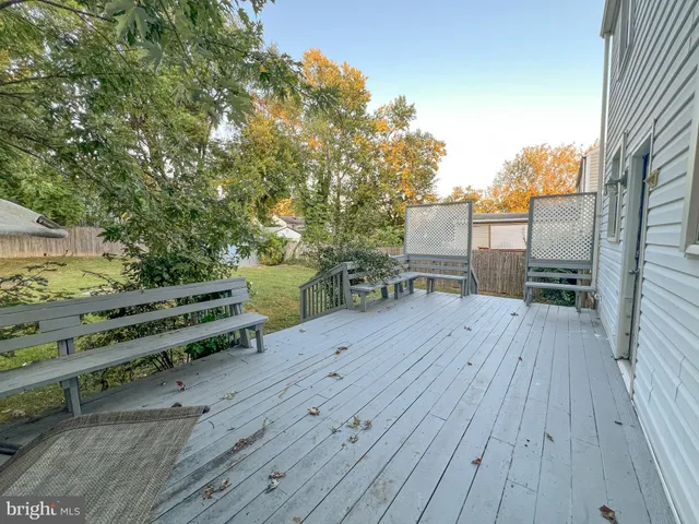 a view of a deck with wooden floor and outdoor seating