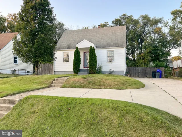 a view of a house with a yard and tree s