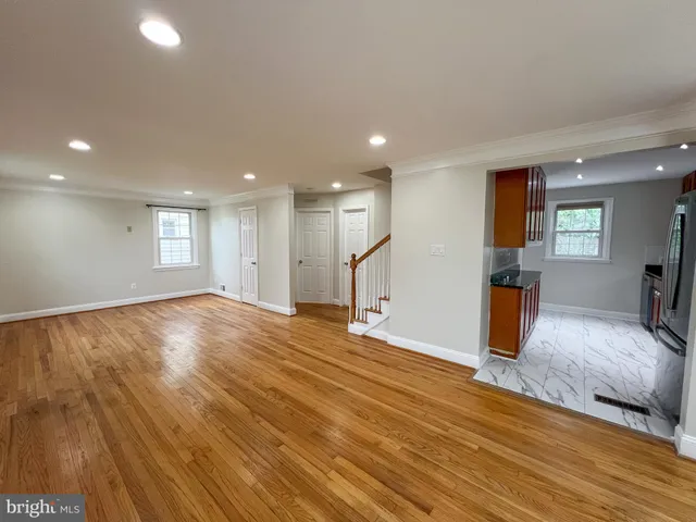 a view of empty room with wooden floor