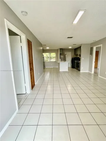 a view of a refrigerator and window in a room