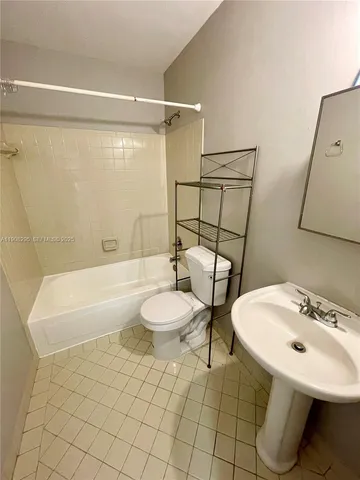 a house that is sitting in the grass with large trees