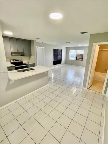 a kitchen that has a sink and a stove in it