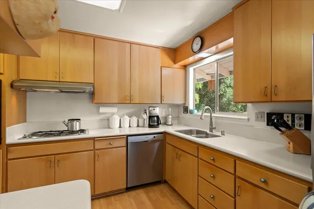 a kitchen with a sink cabinets and window