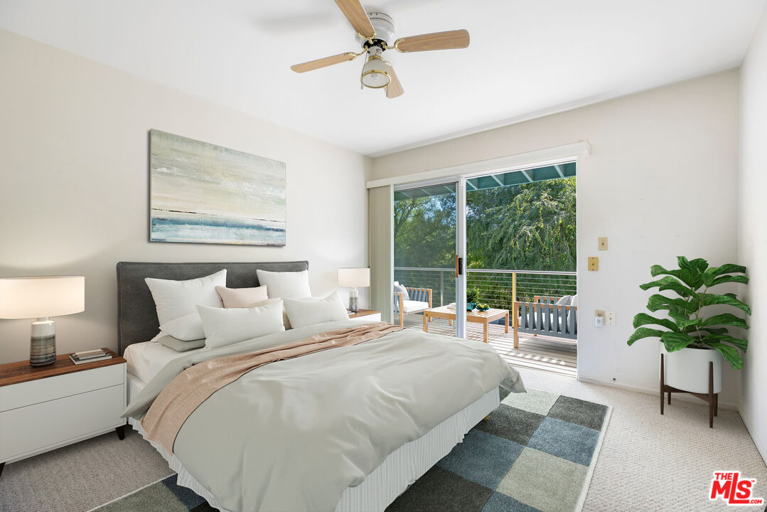 2860 Roscomare Road Los Angeles, CA 90077 - Photo 11 of 15 a bedroom with bed and a potted plant