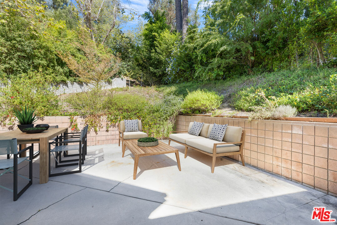 2860 Roscomare Road Los Angeles, CA 90077 - Photo 13 of 15 a view of a patio with a table and chairs