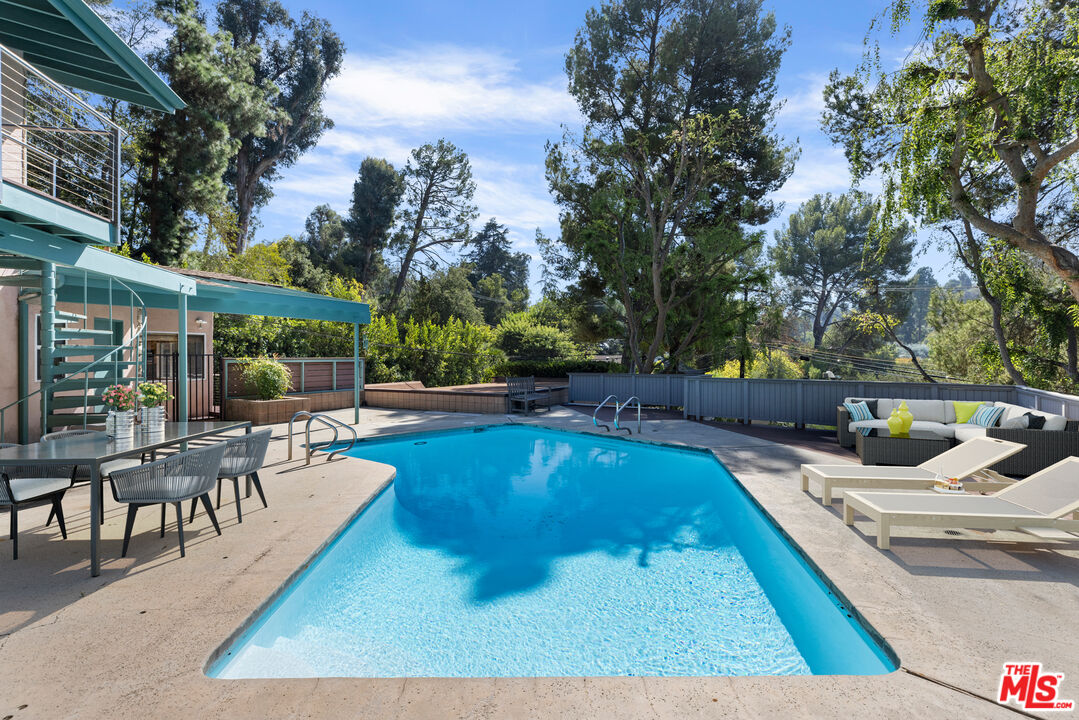 2860 Roscomare Road Los Angeles, CA 90077 - Photo 14 of 15 a view of a swimming pool with chairs