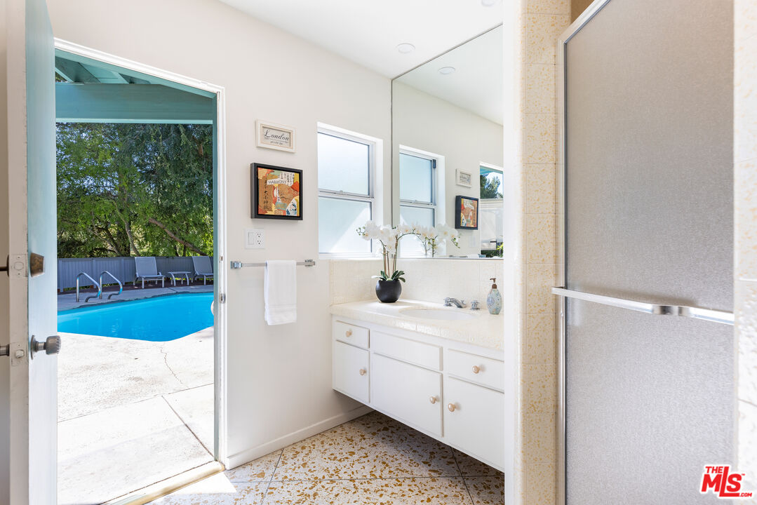 2860 Roscomare Road Los Angeles, CA 90077 - Photo 15 of 15 a bathroom with a sink a mirror and a shower