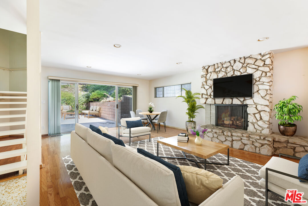 2860 Roscomare Road Los Angeles, CA 90077 - Photo 2 of 15 a living room with furniture a flat screen tv and a large window