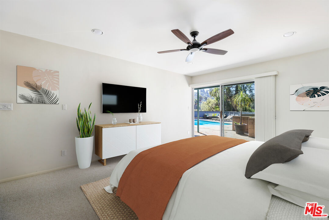 2860 Roscomare Road Los Angeles, CA 90077 - Photo 9 of 15 a bedroom with a bed tv and window