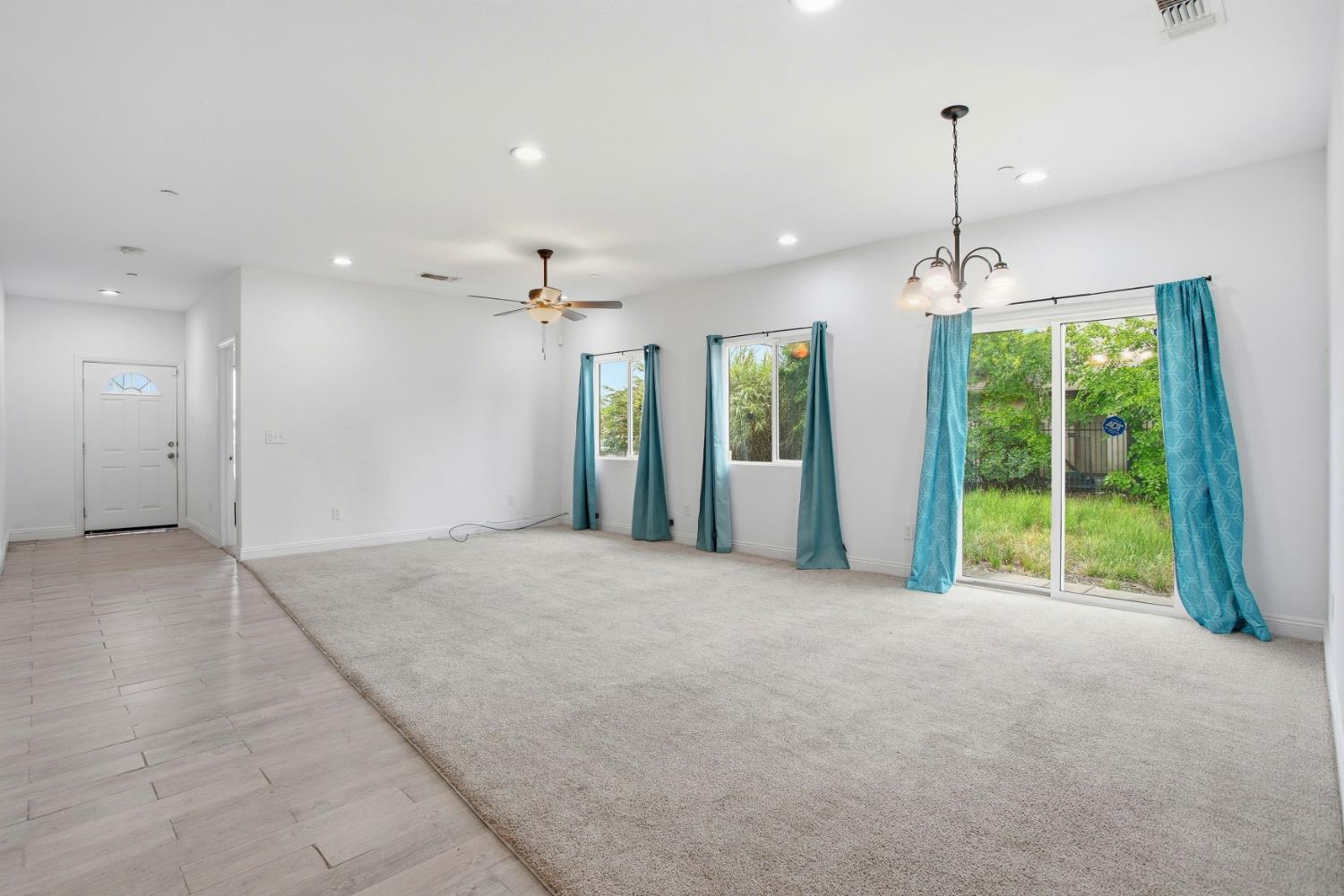 5680 Power Inn Road Sacramento, CA 95824 - Photo 6 of 48 a view of an empty room with windows and chandelier