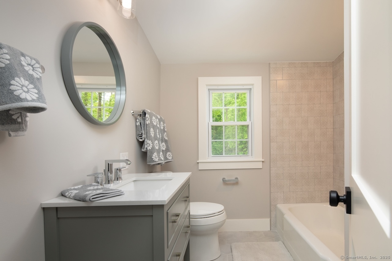 331 Calkinstown Road Sharon, CT 06069 - Photo 13 of 31 a bathroom with a toilet a sink a vanity and a mirror