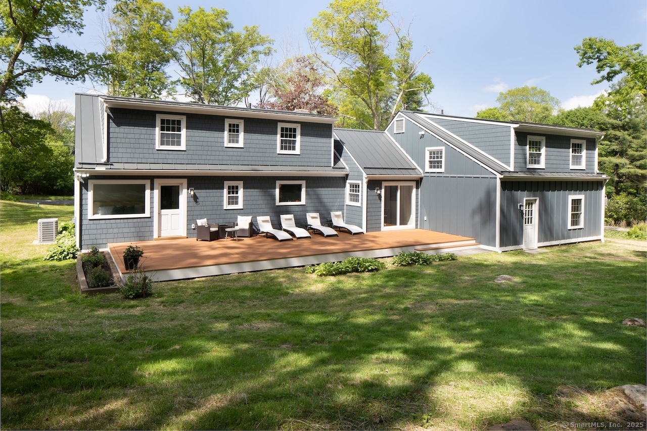 331 Calkinstown Road Sharon, CT 06069 - Photo 4 of 31 a front view of a house with a yard table and chairs