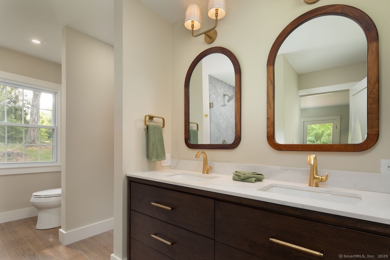 331 Calkinstown Road Sharon, CT 06069 - Photo 7 of 31 a bathroom with a double vanity sink and a large mirror