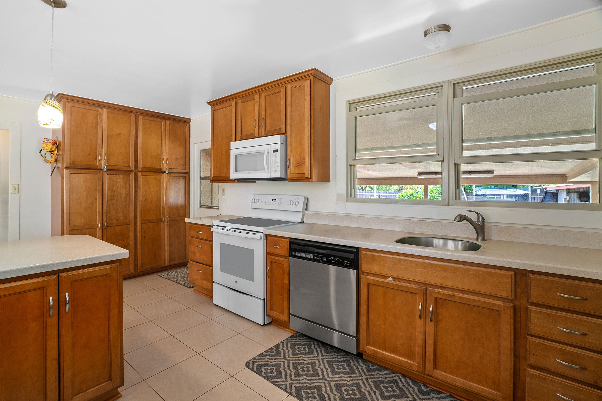 8456 Elepaio Road Kekaha, HI 96752 - Photo 4 of 21 a kitchen with stainless steel appliances granite countertop a sink stove and refrigerator