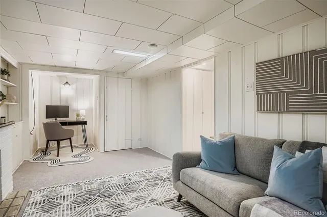 a living room with furniture a lamp and a window