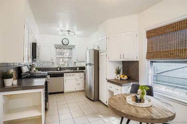 a kitchen with granite countertop a sink appliances cabinets and counter space