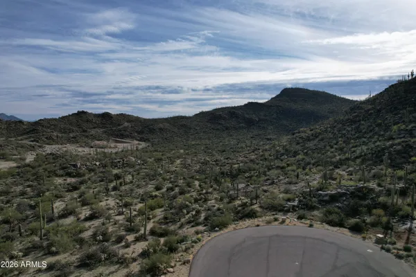 a view of a field with a mountain in the background