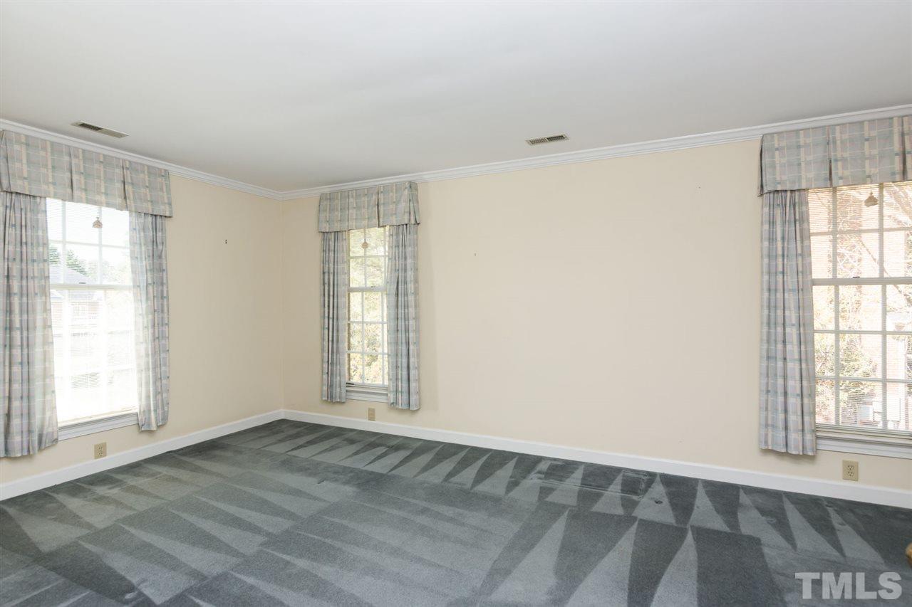 4012 John S Raboteau Wynd Raleigh, NC 27612 - Photo 21 of 25 an empty room with wooden floor and windows