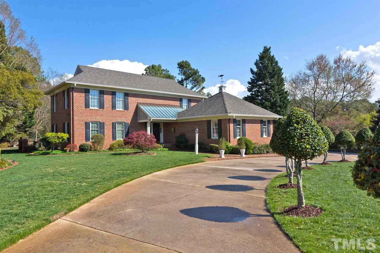 4012 John S Raboteau Wynd Raleigh, NC 27612 - Photo 4 of 25 a front view of a house with a yard and trees