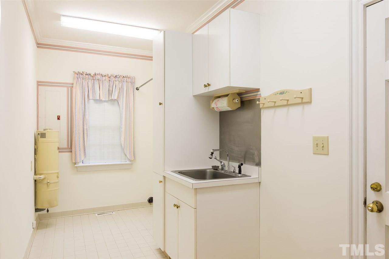 4012 John S Raboteau Wynd Raleigh, NC 27612 - Photo 7 of 25 a bathroom with a sink and mirror