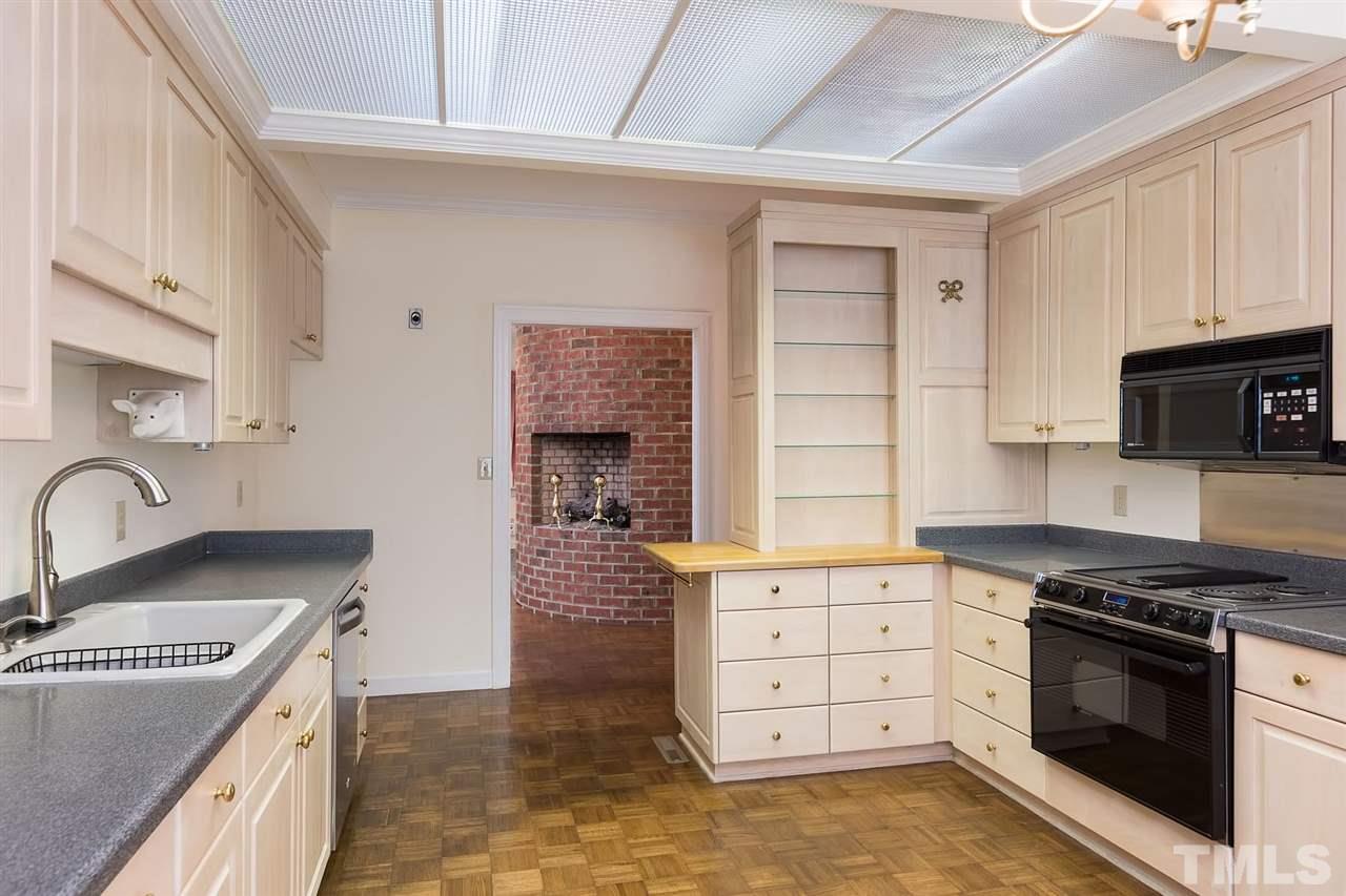 4012 John S Raboteau Wynd Raleigh, NC 27612 - Photo 10 of 25 a kitchen with granite countertop a stove and a sink