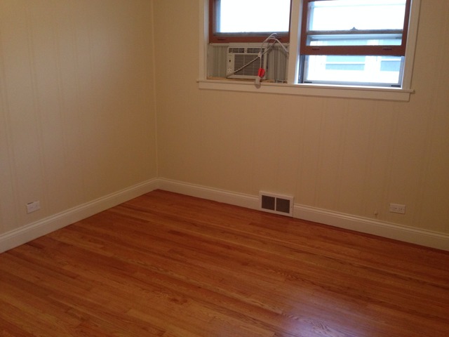 3552 Main Street Skokie, IL 60076 - Photo 4 of 8 an empty room with wooden floor and windows