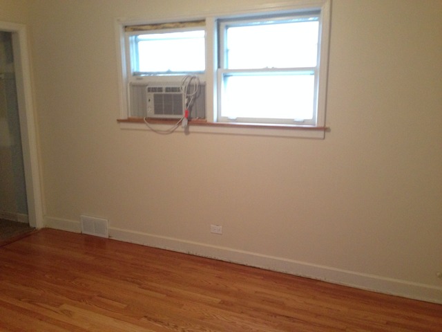 3552 Main Street Skokie, IL 60076 - Photo 7 of 8 an empty room with wooden floor and windows