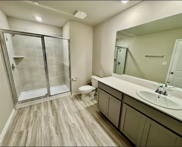 a bathroom with a double vanity sink toilet and shower