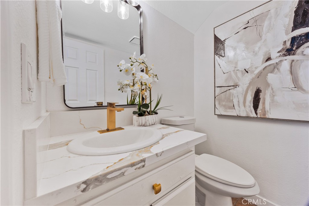 1126 West 228th Street, Unit 16 Torrance, CA 90502 - Photo 13 of 32 a bathroom with a sink a toilet and mirror