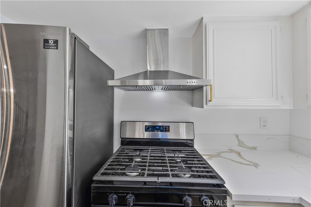 1126 West 228th Street, Unit 16 Torrance, CA 90502 - Photo 14 of 32 a stove top oven sitting inside of a kitchen