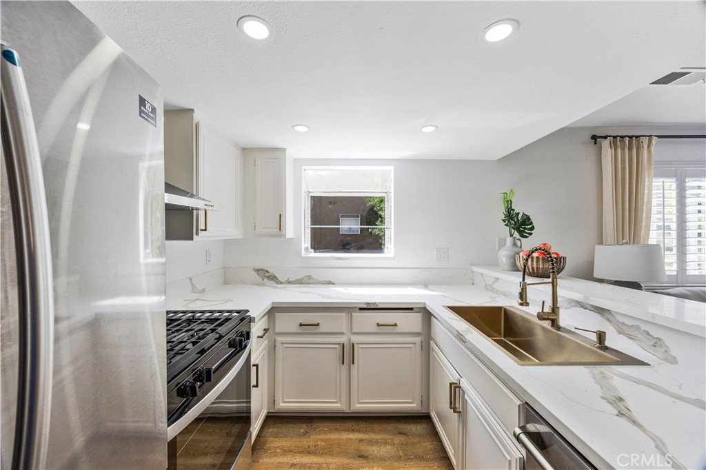 1126 West 228th Street, Unit 16 Torrance, CA 90502 - Photo 7 of 32 a kitchen that has a sink a stove and window