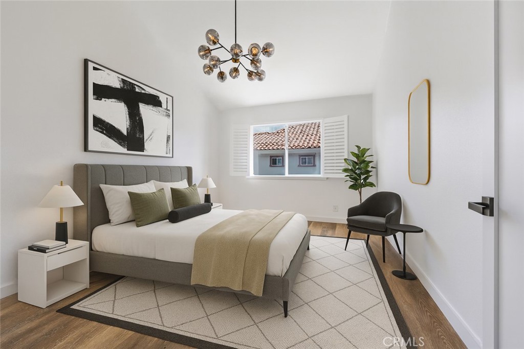 1126 West 228th Street, Unit 16 Torrance, CA 90502 - Photo 8 of 32 a bedroom with a bed and a chair with the potted plant