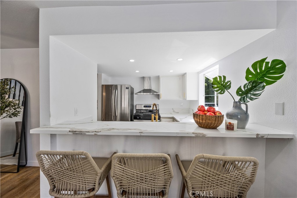 1126 West 228th Street, Unit 16 Torrance, CA 90502 - Photo 10 of 32 a dining room with furniture and a potted plant