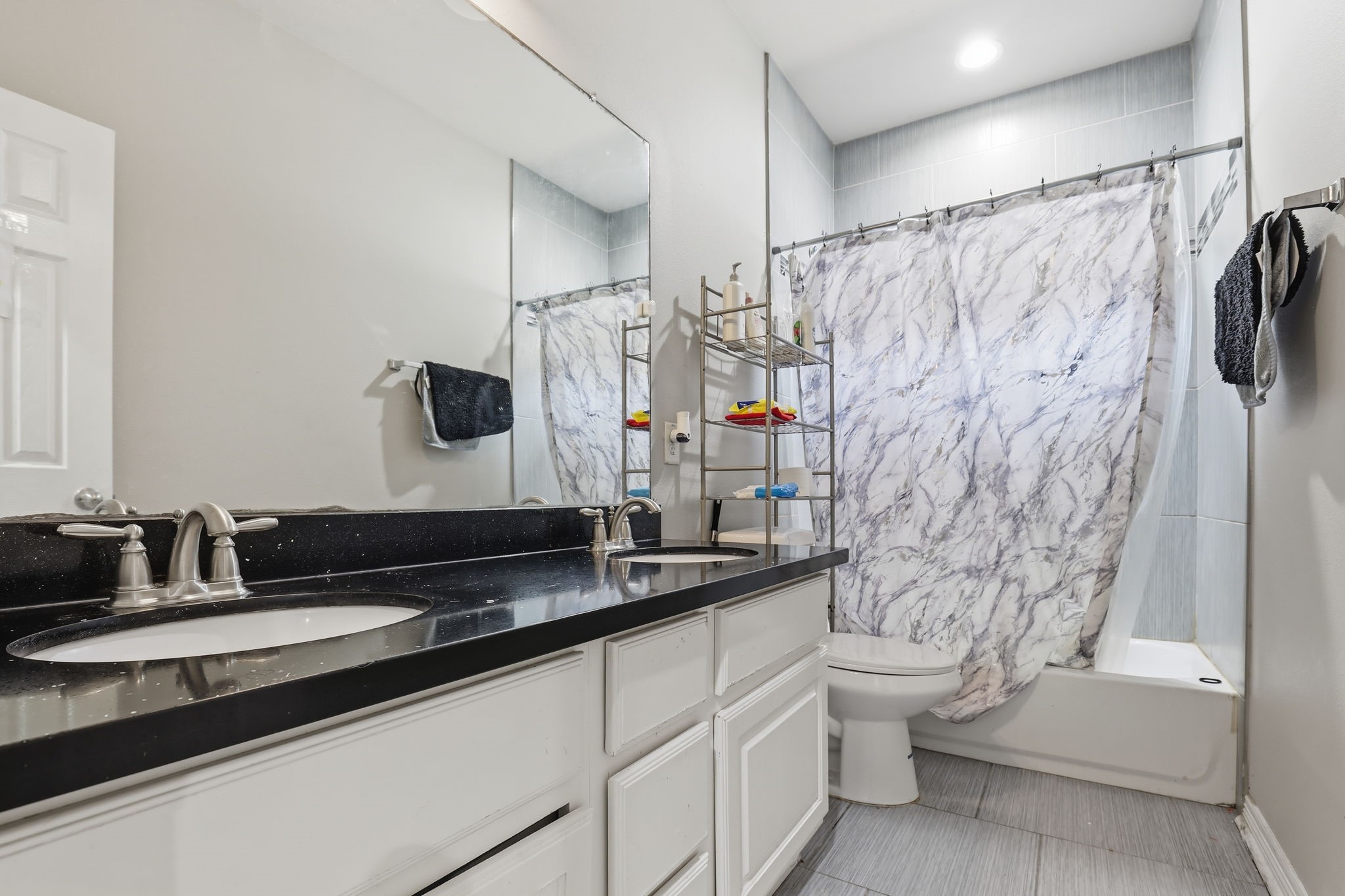 7243 Foxtail Meadow Humble, TX 77338 - Photo 6 of 13 a bathroom with a double vanity sink toilet and shower