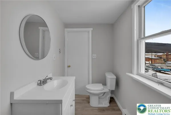 a bathroom with a sink mirror and toilet