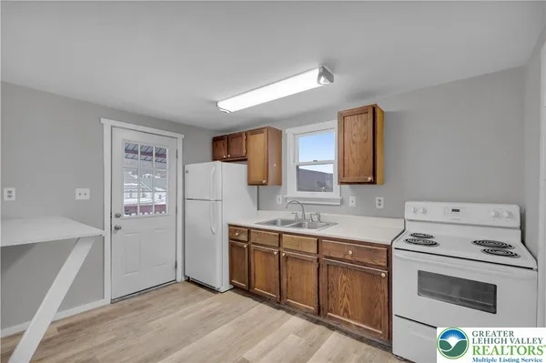 a utility room with cabinets washer and dryer