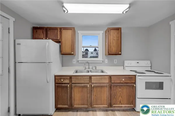 a kitchen with a refrigerator and a sink