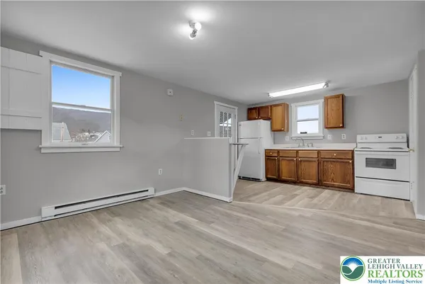 a view of a kitchen with microwave and cabinets