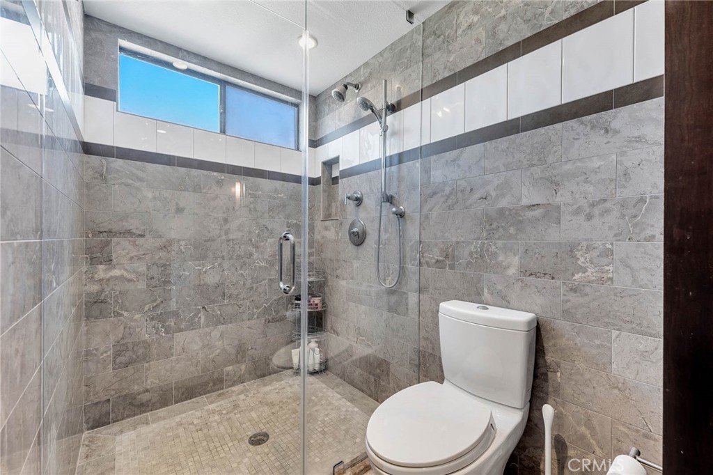 4222 Troost Avenue, Unit 21 Studio City, CA 91604 - Photo 14 of 47 a white toilet sitting next to a bath tub shower