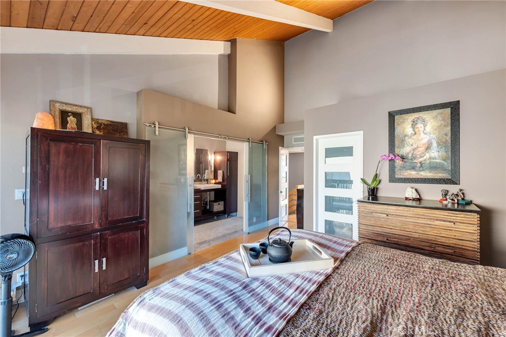 4222 Troost Avenue, Unit 21 Studio City, CA 91604 - Photo 20 of 47 a bedroom with a bed and wooden floor