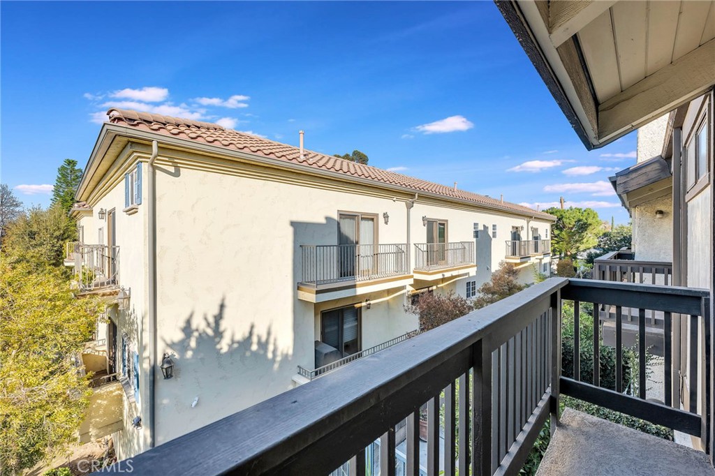 4222 Troost Avenue, Unit 21 Studio City, CA 91604 - Photo 26 of 47 a view of a balcony with wooden floor and iron stairs