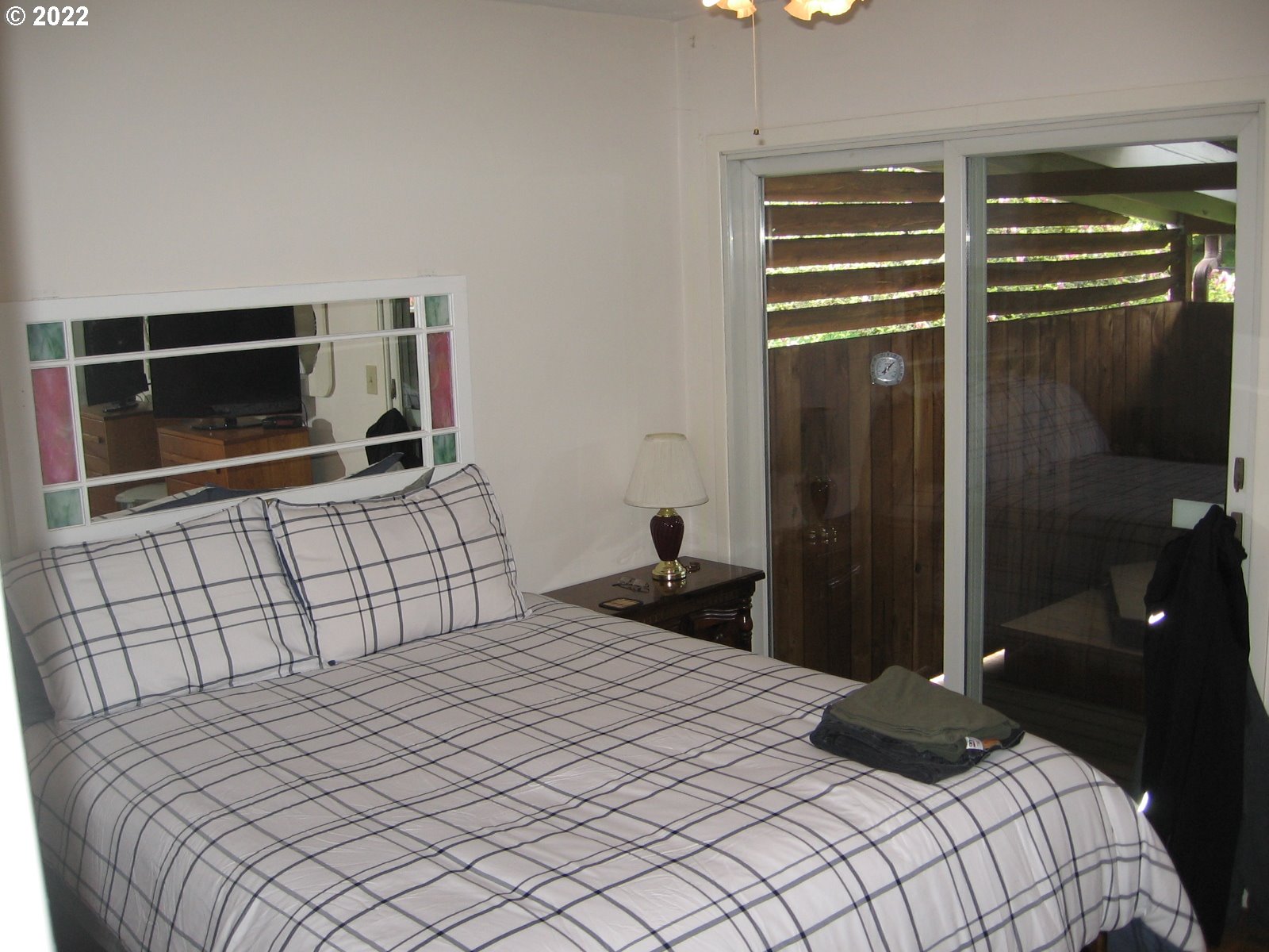 1023 Northeast 172nd Avenue Portland, OR 97230 - Photo 13 of 23 a bedroom with a bed and a flat tv screen