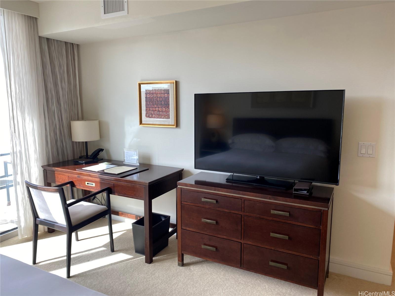 223 Saratoga Road, Unit 2316 Honolulu, HI 96815 - Photo 6 of 20 a living room with furniture and a flat screen tv